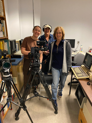 DP, sound engineer and Director standing beside camera equipment